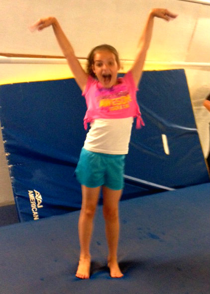 Sticking the landing (almost, what are those hands?) at the last gymnastics practice. 