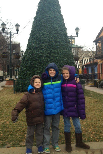 My Kids in Front of An Evergreen Tree.
